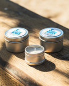 Luxury scented candle in glass jar with warm glowing light – hand-poured soy wax.