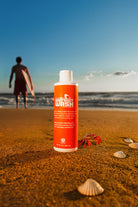 Bottle of Wetsuit Wash eco-friendly neoprene cleaner for surf and dive gear.